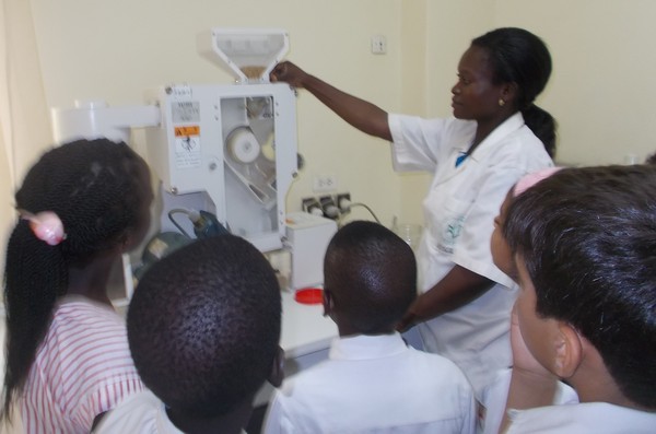 Mrs. Fifame showed us a machine that takes the skin off the rice grain