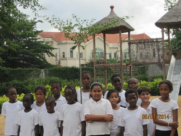 Years 4 & 5 stand in front of the tree planted on Earth Day 2013.